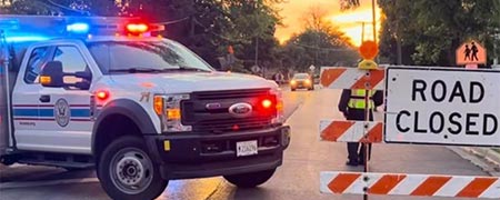 Public safety photo, depicting a police car and road construction sign.